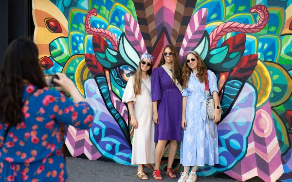 Ladies posing by a mural at Wynwood Walls